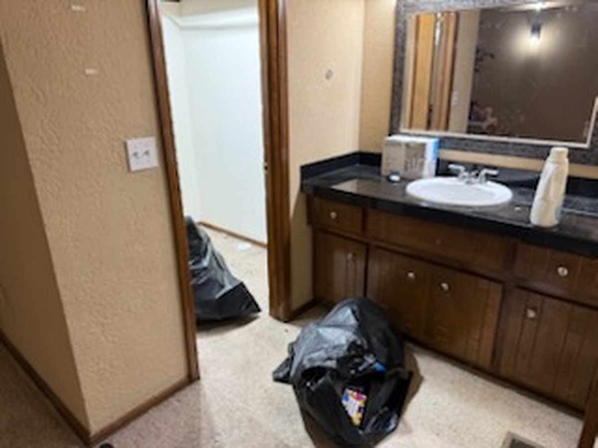 Bagged household items ready for removal from an Oklahoma City bathroom