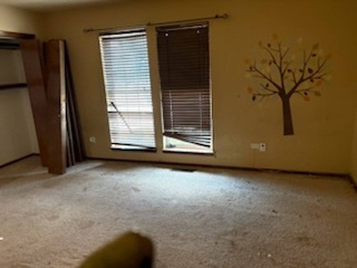 Empty bedroom after a full-house cleanout in Oklahoma City