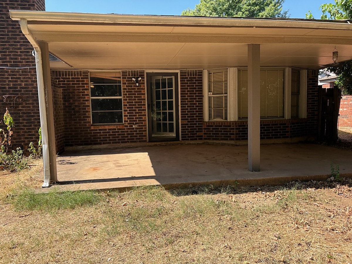 Back patio cleared after a move-out cleanout in Oklahoma City