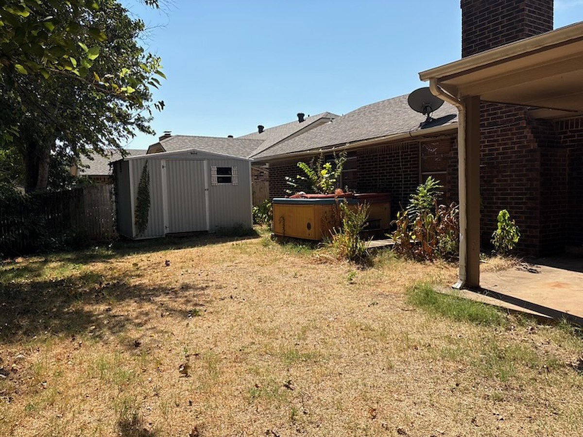 Backyard cleared after a move-out cleanout in Oklahoma City