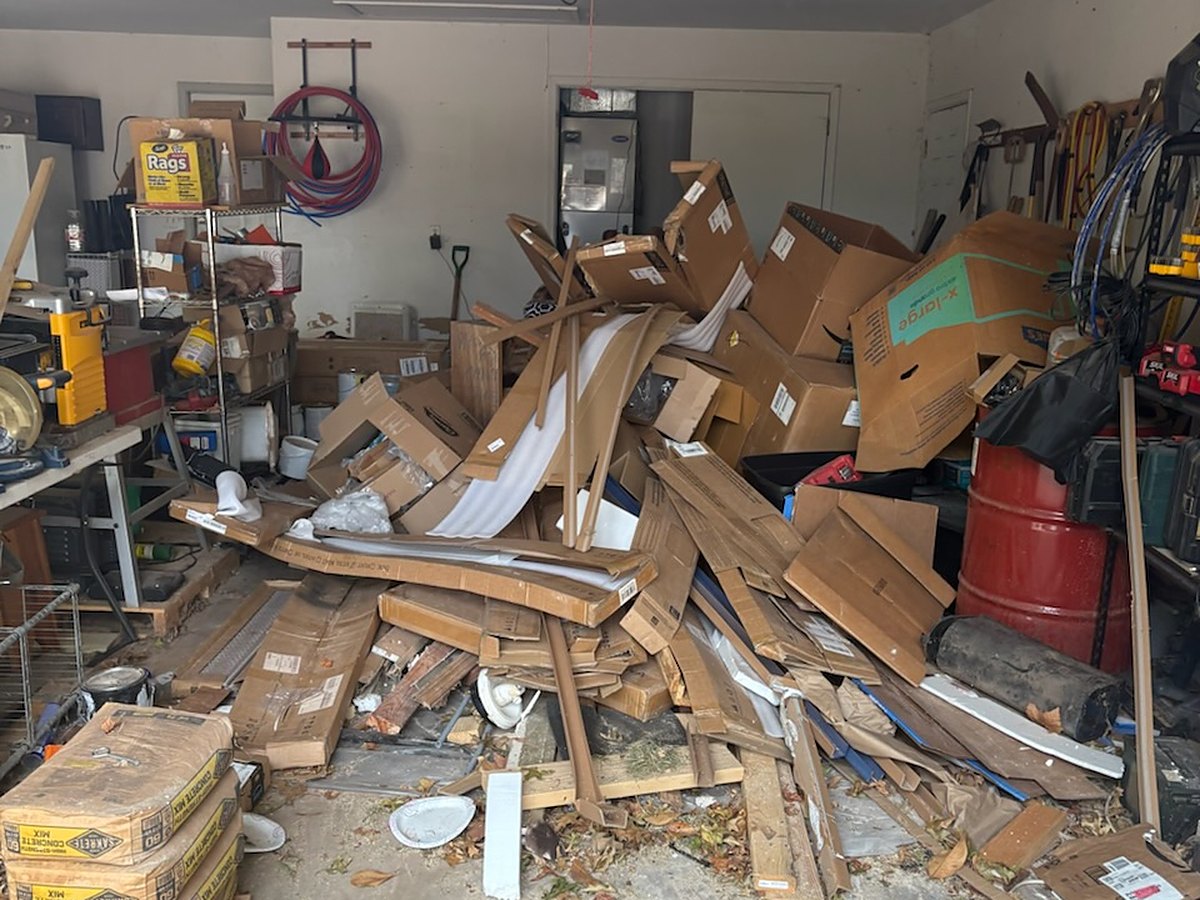Garage packed with boxes and lumber before junk removal in Oklahoma City